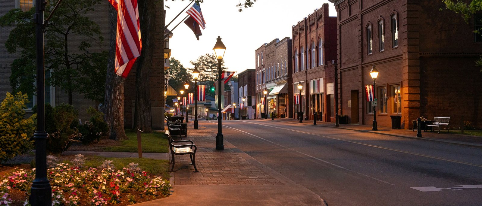 Historic St. Joseph, Missouri main street at dusk with American flags